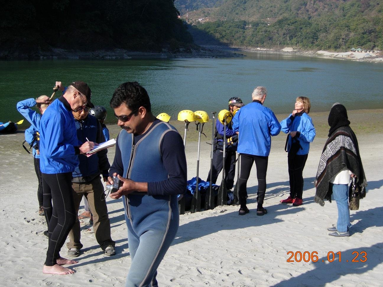film crew shooting movie near lake with camera equipment and scenic natural background